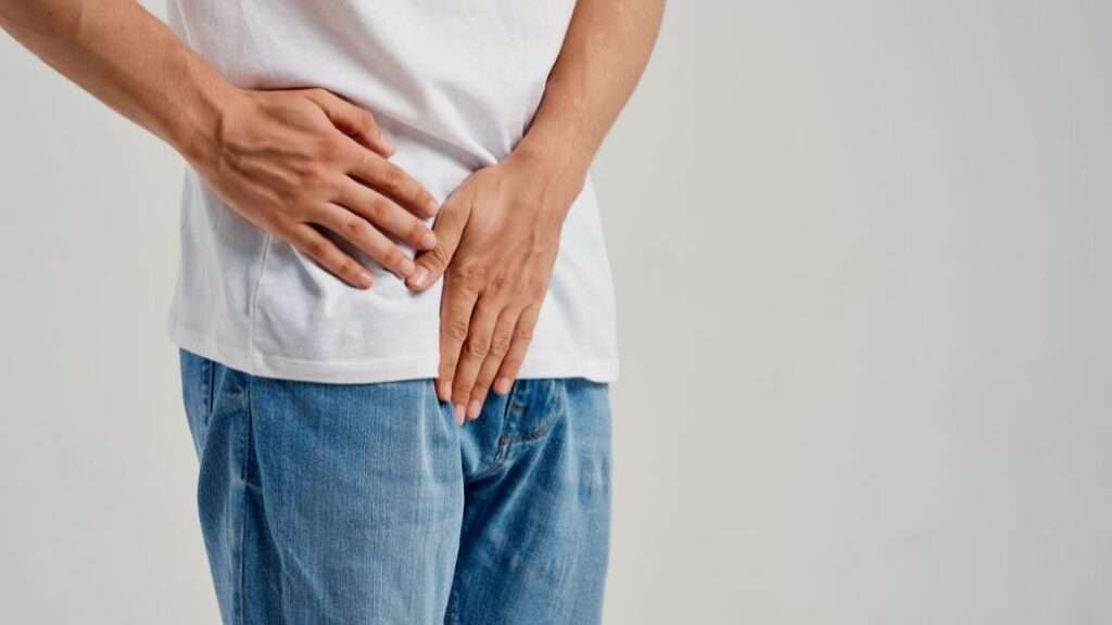 Man covering his crotch as he needs erectile dysfunction treatment
