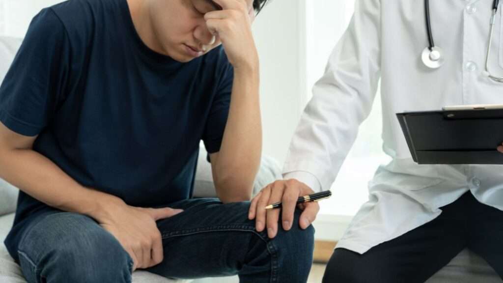 Man getting comforted by a pharmacist over premature ejaculation concerns