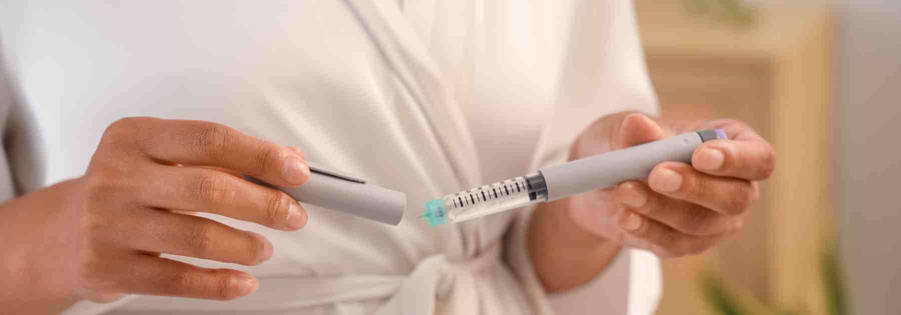 Woman using a Wegovy weight loss pen